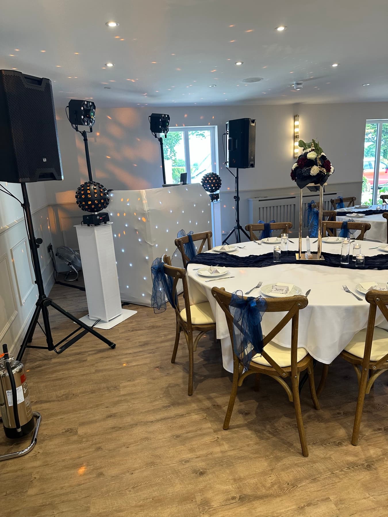 White DJ booth and lighting set up for a wedding reception